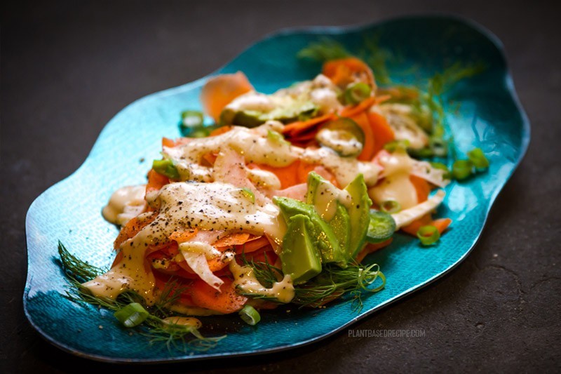 Tahini salad dressing drizzled over the carrots, avocado, and fennel.