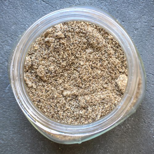 Ground up chia seeds in a glass jar.