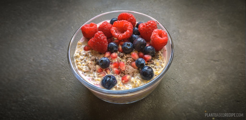 Layered overnight oatmeal with chia, topped with berries.