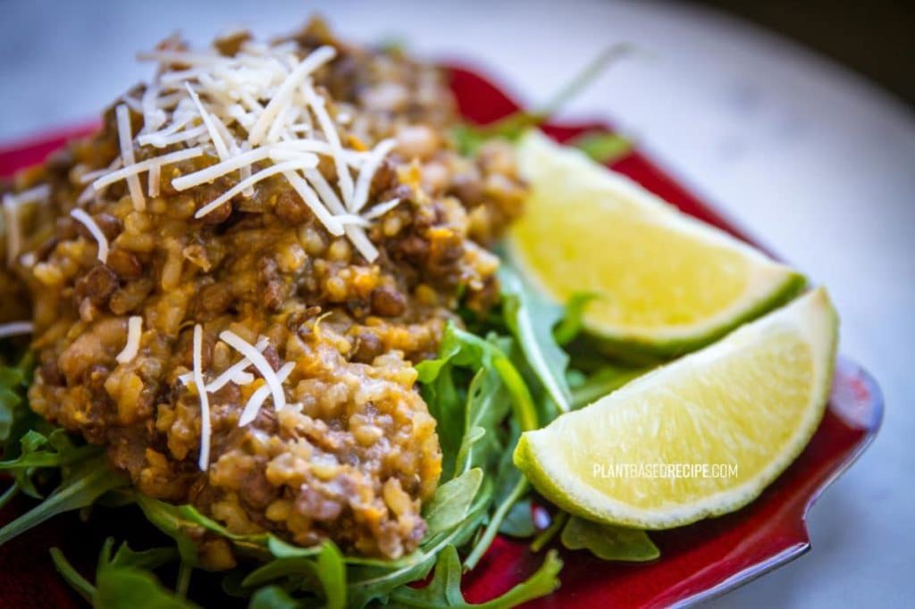 Garnish this bean and lentil dish with lime and vegan parmesan.