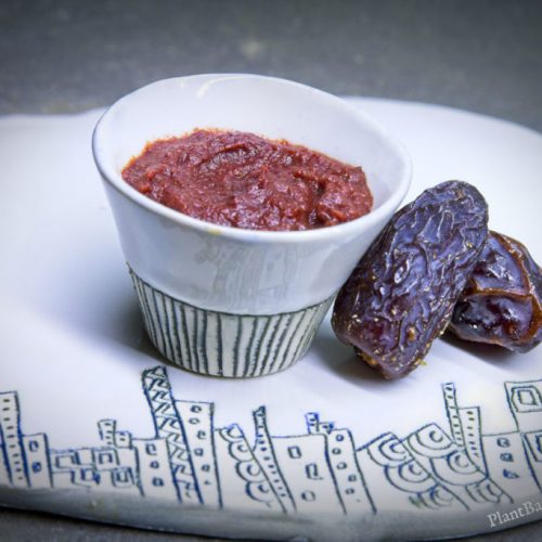 Date paste in a small bowl with dates next to it