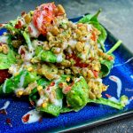 Vegan farro and vegetable salad mixed with oil-free pesto.