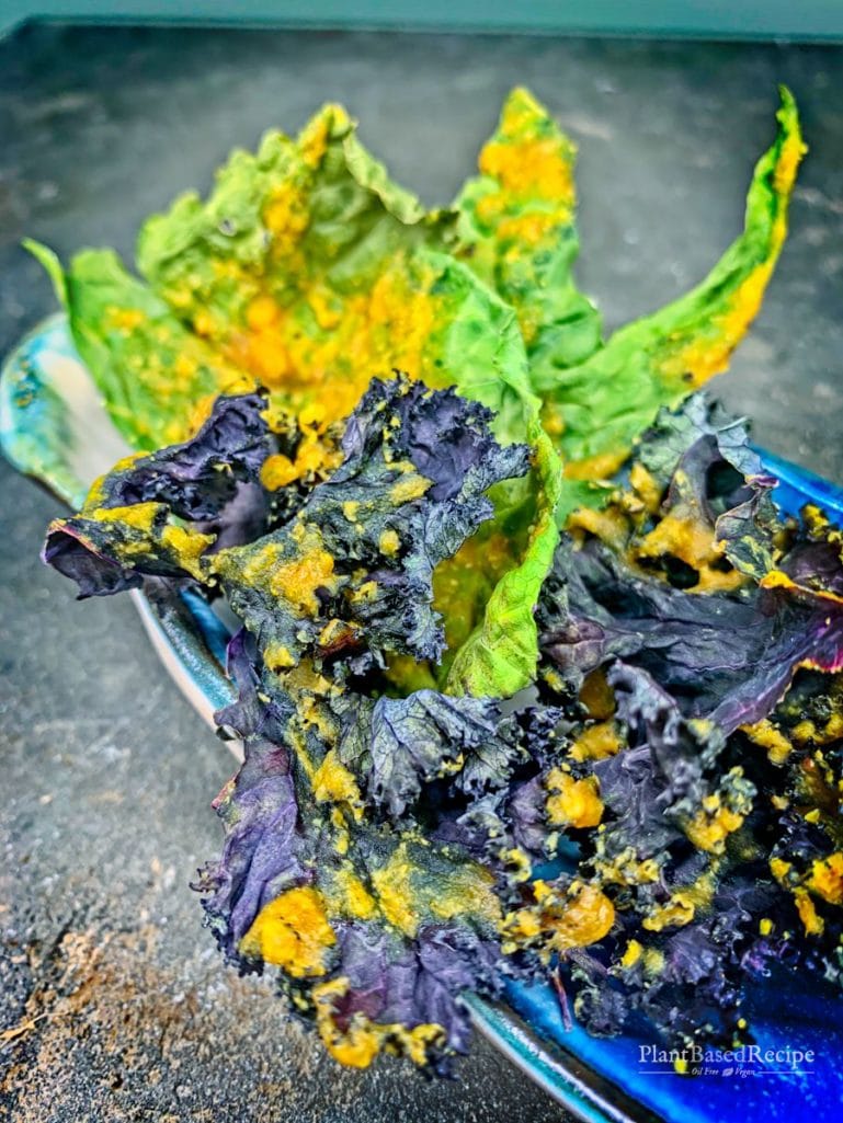 Baked kale chip recipe is vegan and oil free, featuring turmeric, lemon and nutritional yeast.