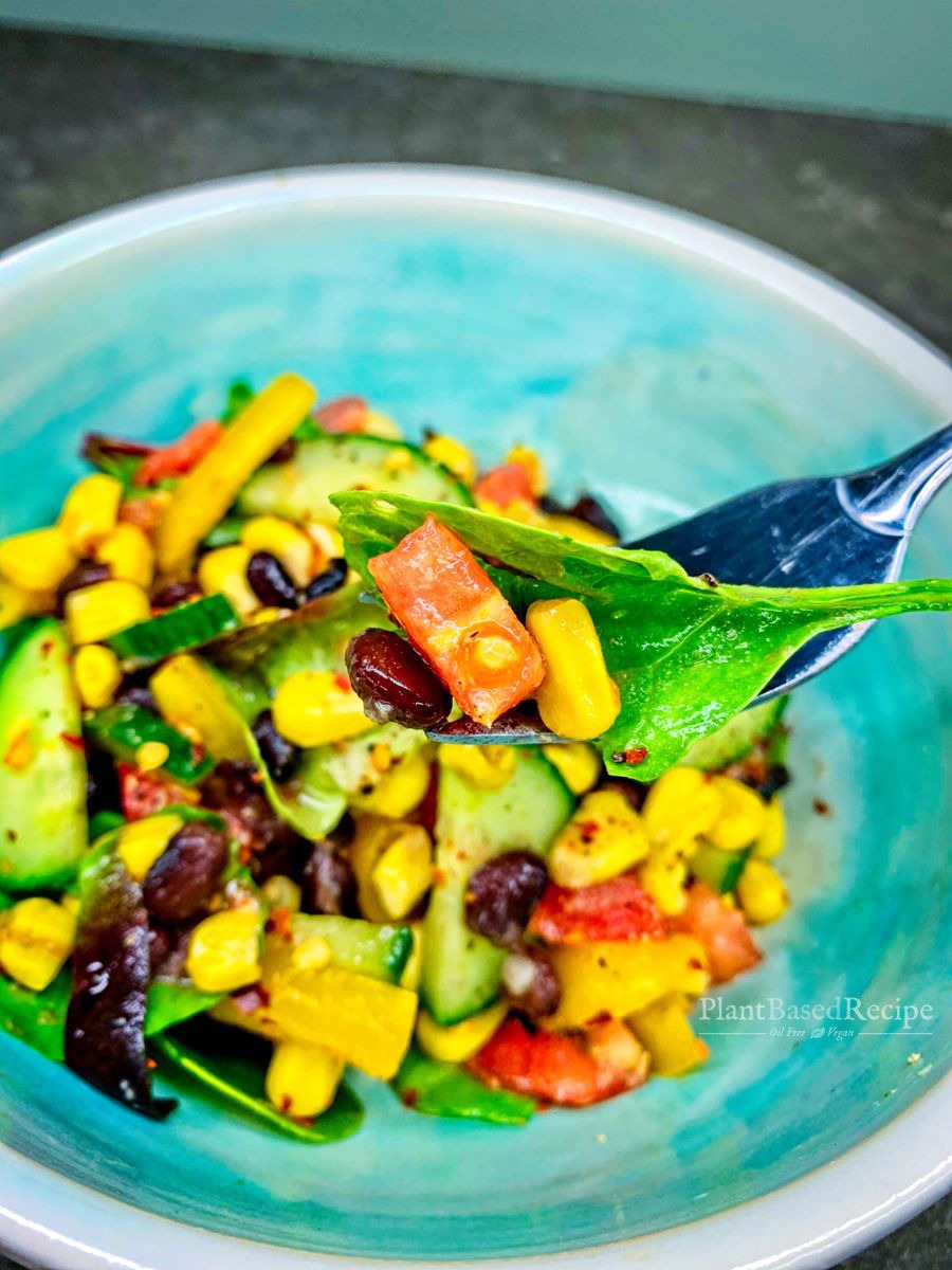 Recipe for a oil free vegan side salad that includes beans, corn, vegetables with a ginger orange dressing.